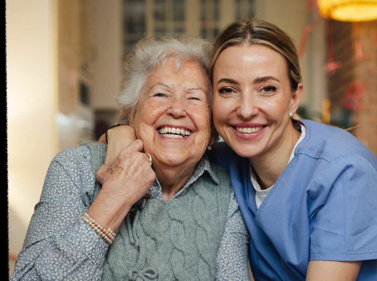 A Nova Leap caregiver smiling with an elderly client